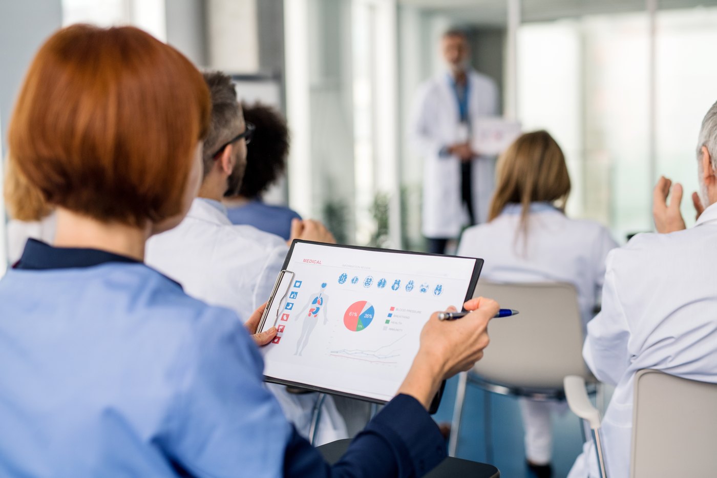 Clinicians attending a presentation at a medical conference